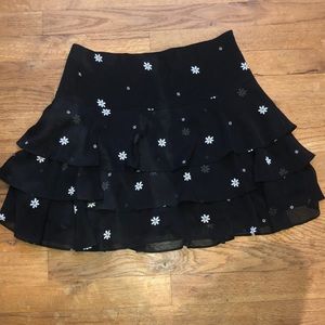 Black mini skirt with white daisy pattern